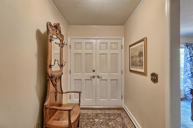 doorway to outside with baseboards, ornamental molding, and a textured ceiling