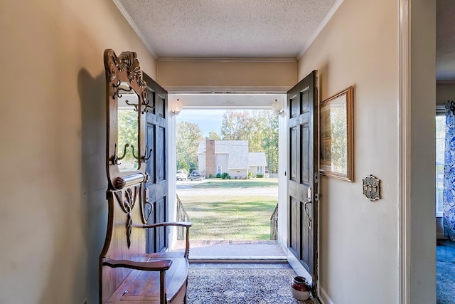 entryway featuring a textured ceiling and crown molding