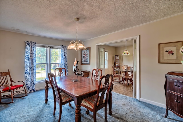 dining space with a chandelier, carpet flooring, crown molding, and baseboards