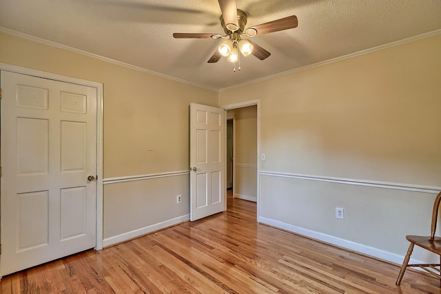 unfurnished bedroom with light wood-style floors, baseboards, and crown molding