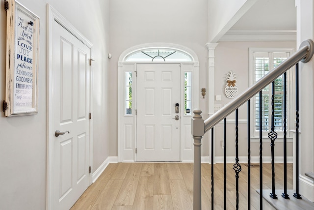 entryway featuring decorative columns and light wood-type flooring