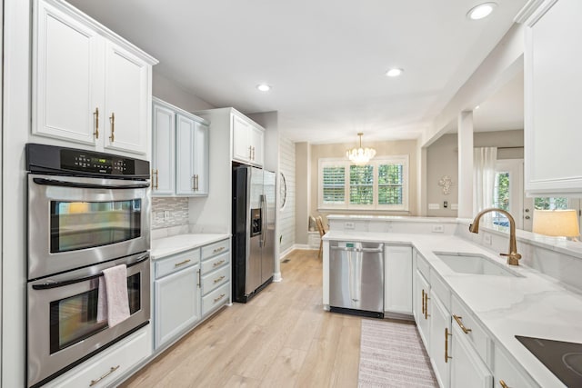 kitchen featuring appliances with stainless steel finishes, sink, and white cabinets