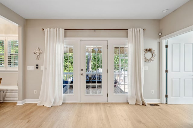 doorway to outside with light wood-type flooring