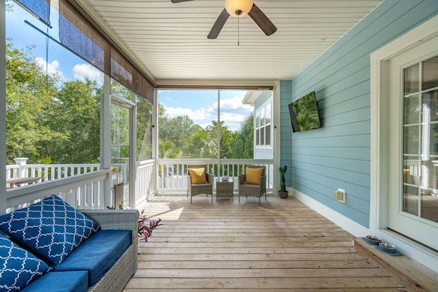 sunroom / solarium featuring ceiling fan