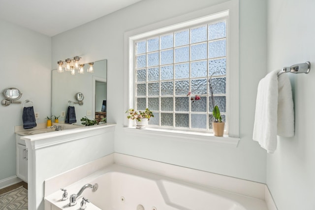 bathroom featuring vanity and a bath