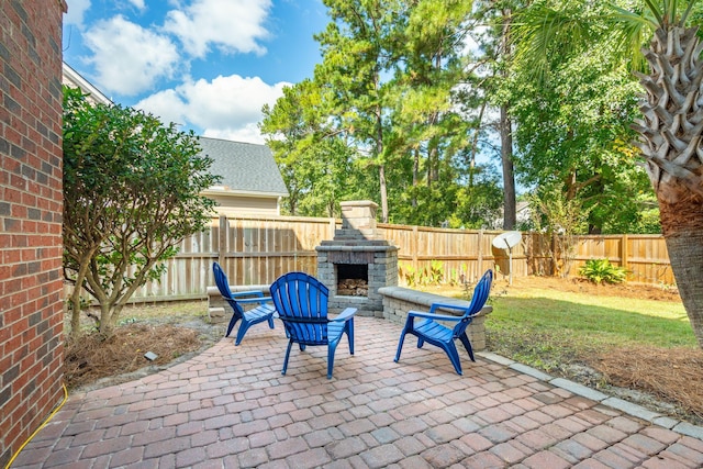 view of patio / terrace featuring an outdoor stone fireplace