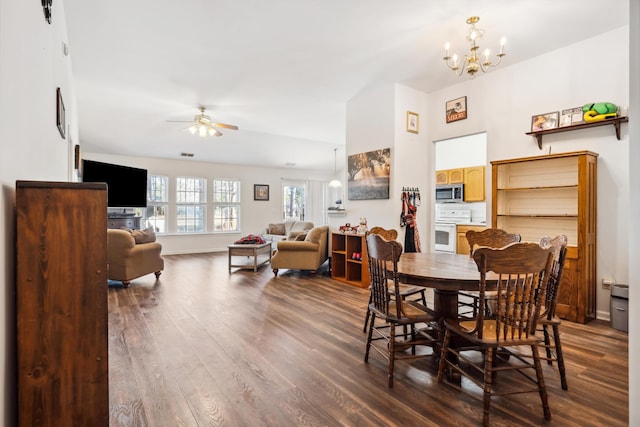 dining room featuring hardwood / wood-style flooring and ceiling fan with notable chandelier