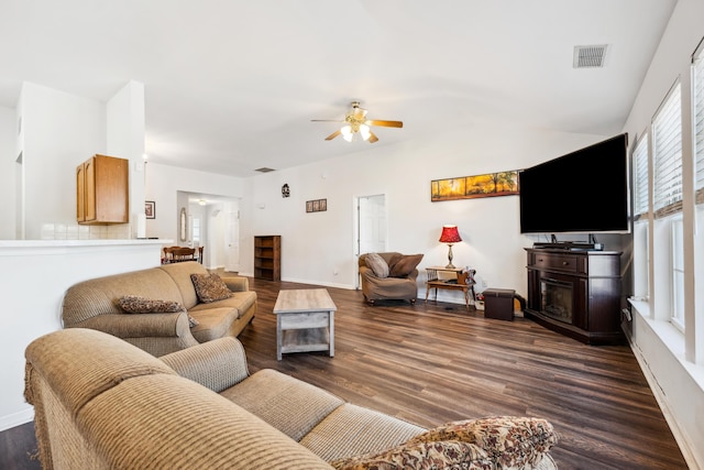 living room with ceiling fan and dark hardwood / wood-style floors