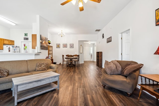 living room with hardwood / wood-style flooring and ceiling fan with notable chandelier