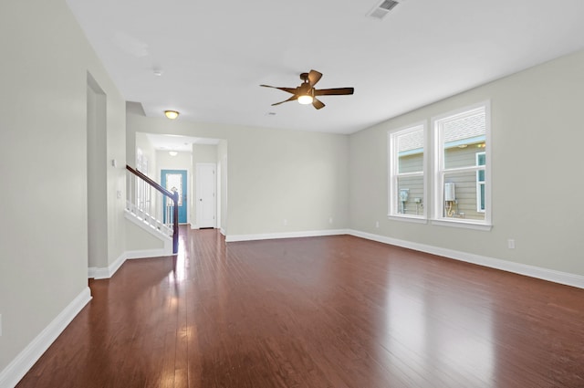 spare room with ceiling fan and dark wood-type flooring