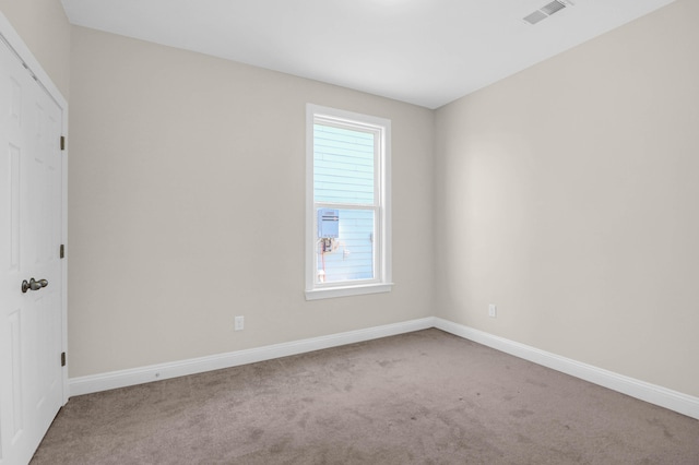 unfurnished room featuring light colored carpet