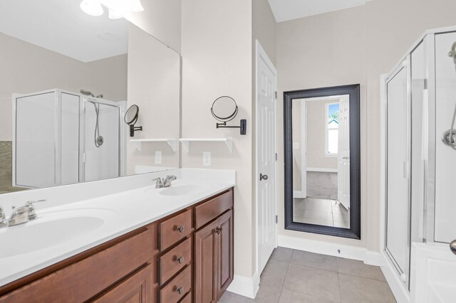 bathroom featuring tile patterned floors, vanity, and walk in shower