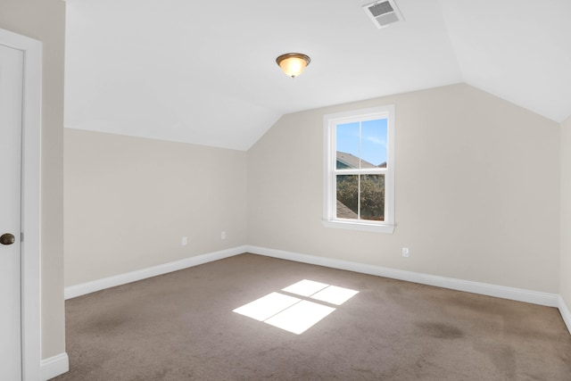 additional living space with light colored carpet and lofted ceiling