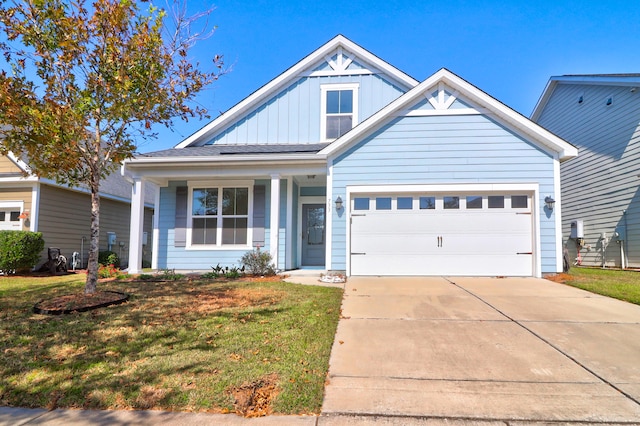 craftsman house with a front lawn and a garage