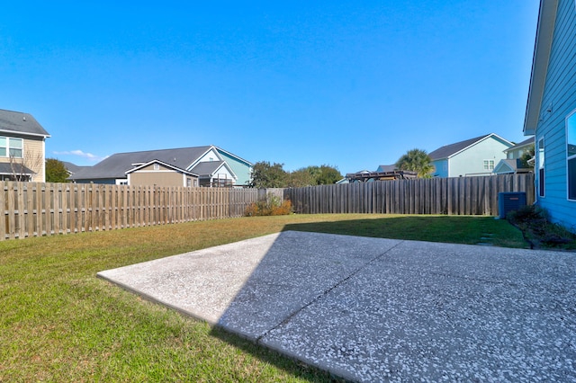 view of yard with cooling unit and a patio