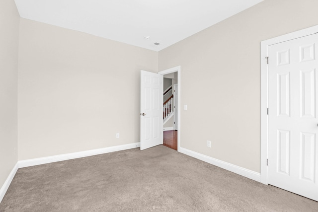 unfurnished bedroom featuring light colored carpet