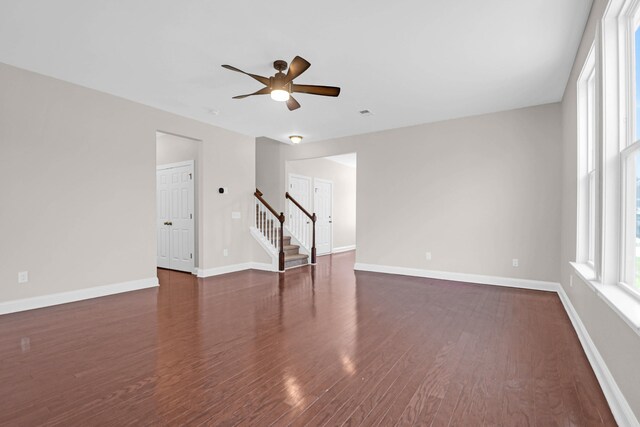 spare room with ceiling fan and dark hardwood / wood-style flooring