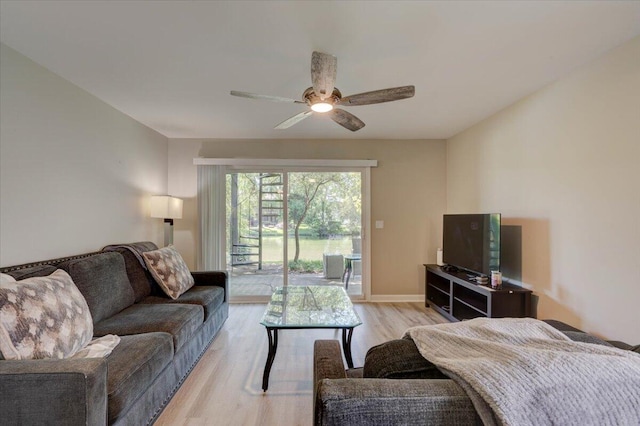 living room featuring ceiling fan and light wood-type flooring