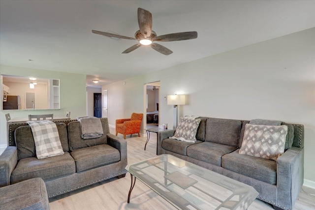 living room with hardwood / wood-style floors and ceiling fan