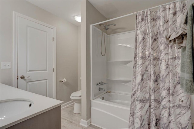 full bathroom featuring hardwood / wood-style floors, vanity, shower / bath combo, and toilet