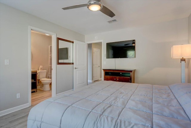 bedroom with hardwood / wood-style flooring, ensuite bath, and ceiling fan