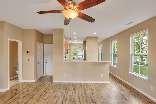 interior space with ceiling fan, a healthy amount of sunlight, and light hardwood / wood-style flooring