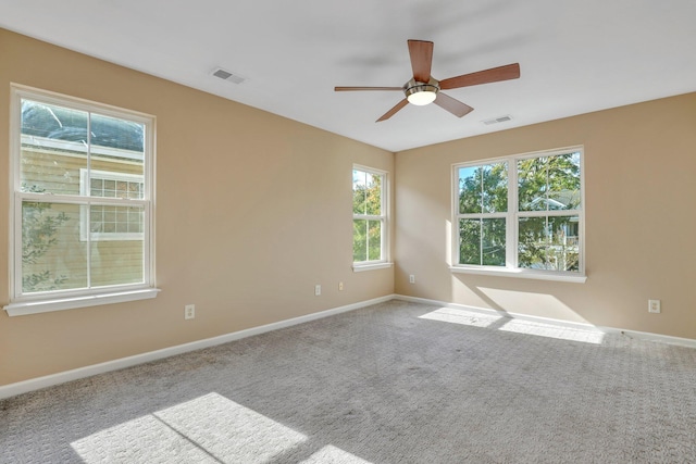 carpeted spare room with ceiling fan