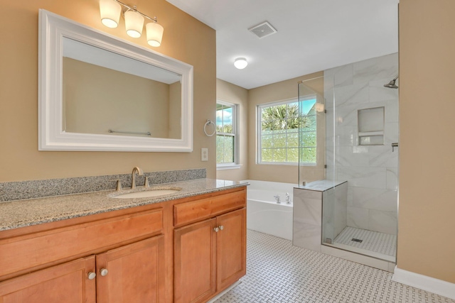 bathroom with tile patterned floors, vanity, and separate shower and tub