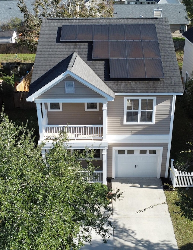 view of front of property featuring a balcony and a garage