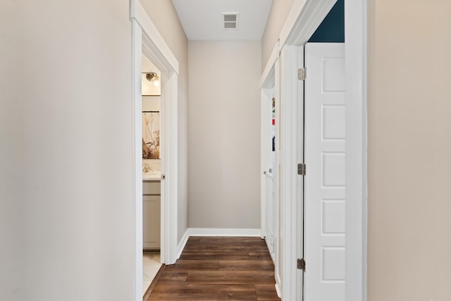 hall featuring sink and dark hardwood / wood-style floors