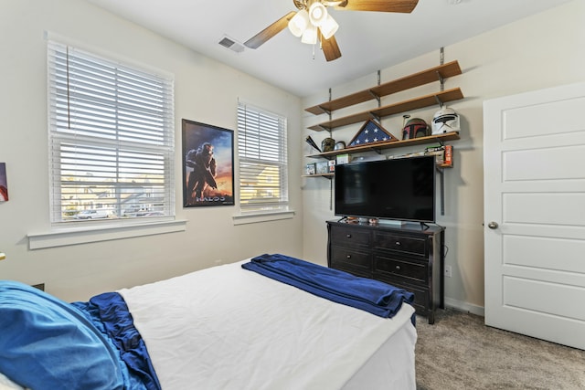 carpeted bedroom with multiple windows and ceiling fan