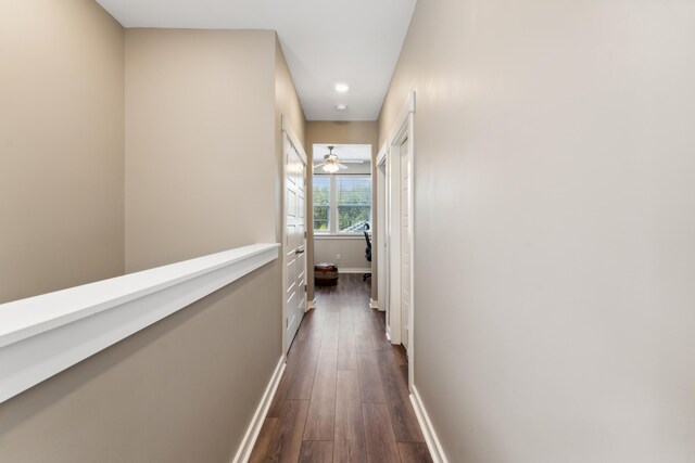 corridor with dark hardwood / wood-style flooring