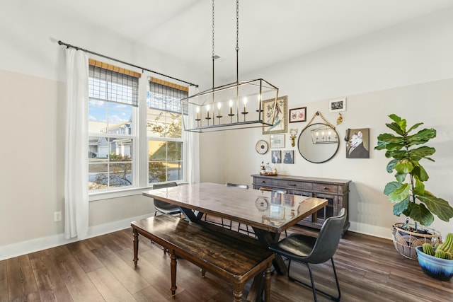 dining room with dark hardwood / wood-style floors, plenty of natural light, and a notable chandelier