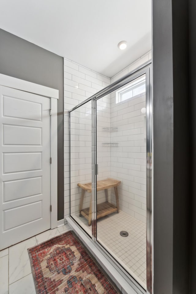 bathroom featuring a shower with shower door