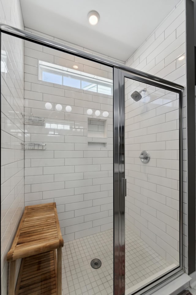 bathroom featuring a shower with door