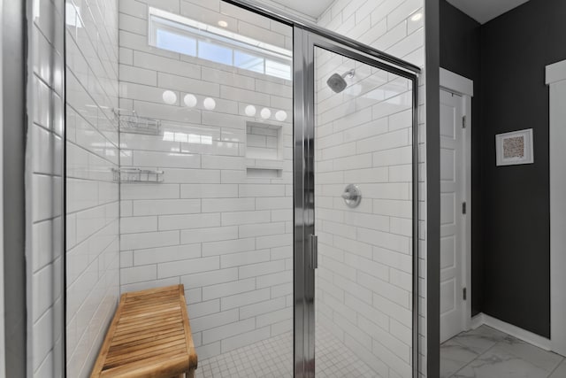 bathroom with a shower with door