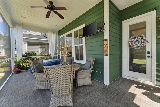 sunroom / solarium featuring ceiling fan