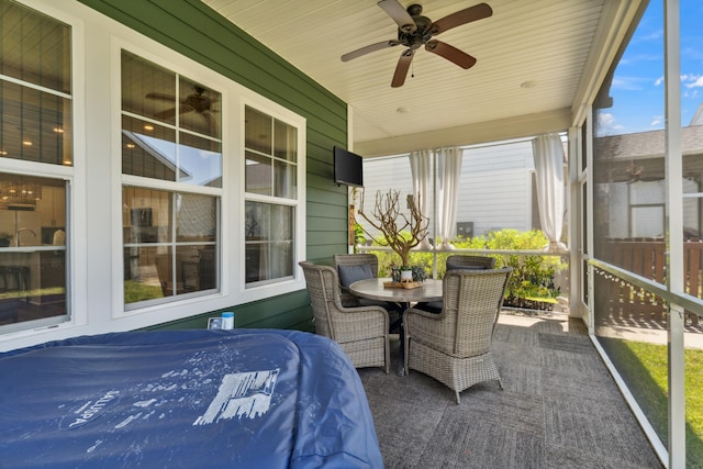 sunroom / solarium with ceiling fan, wood ceiling, and vaulted ceiling