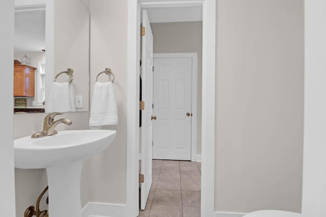 bathroom with tile patterned flooring and sink