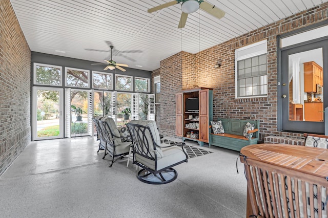 sunroom featuring ceiling fan