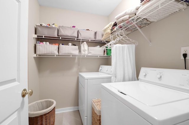 clothes washing area featuring washer and clothes dryer