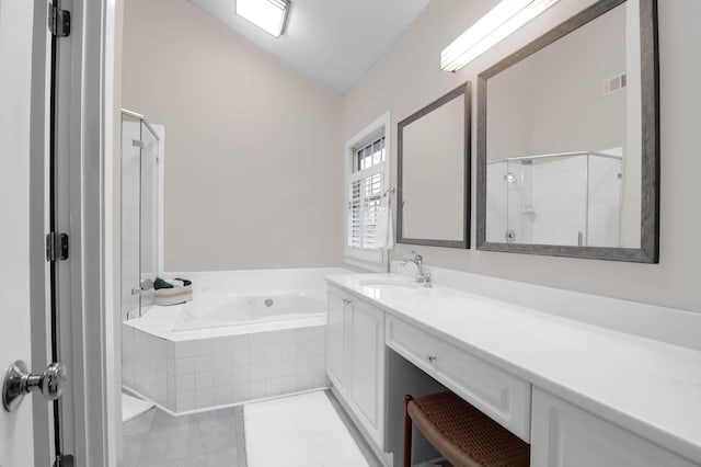 bathroom with plus walk in shower, lofted ceiling, vanity, and tile patterned floors