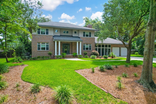 view of front of property with a garage and a front lawn