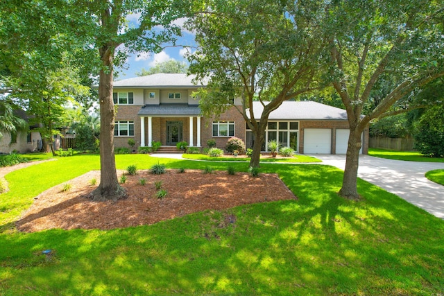 view of front facade featuring a garage, a front lawn, and a porch