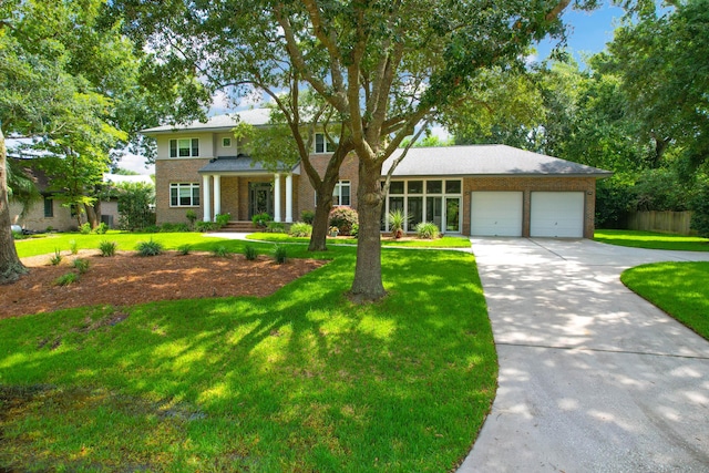 view of front of house with a garage and a front yard