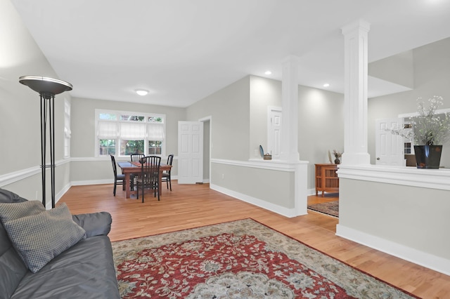 living room featuring hardwood / wood-style flooring and decorative columns