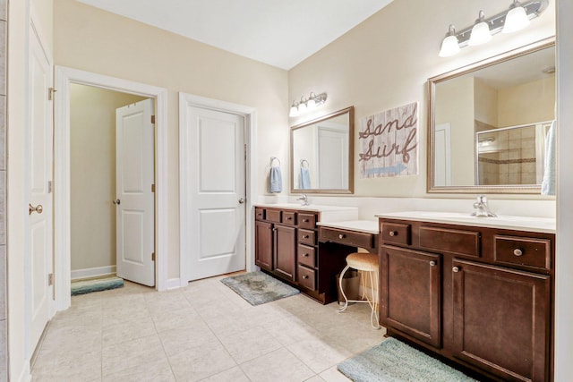 bathroom with tile patterned flooring, a shower with shower door, and vanity