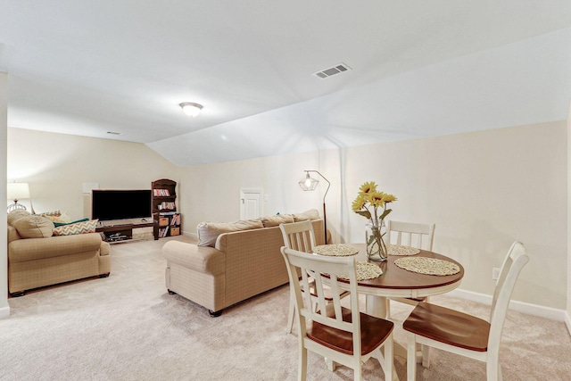 interior space featuring vaulted ceiling and light carpet