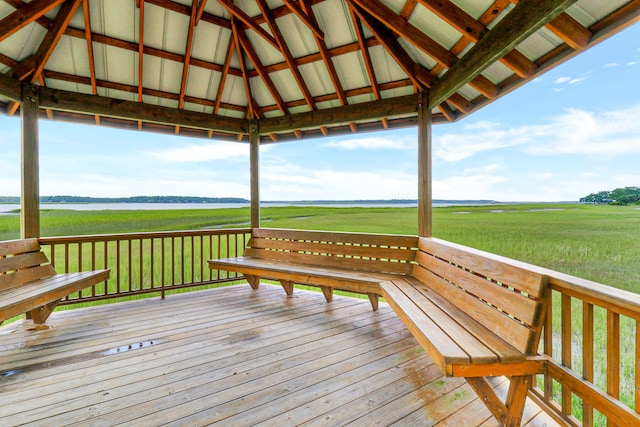 wooden deck with a rural view, a gazebo, and a yard