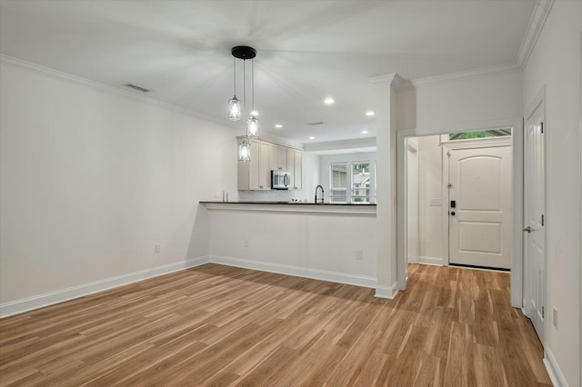 kitchen with visible vents, stainless steel microwave, ornamental molding, recessed lighting, and light wood-style flooring